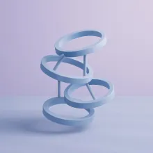 Abstract sculpture with four rings stacked and connected by rods.