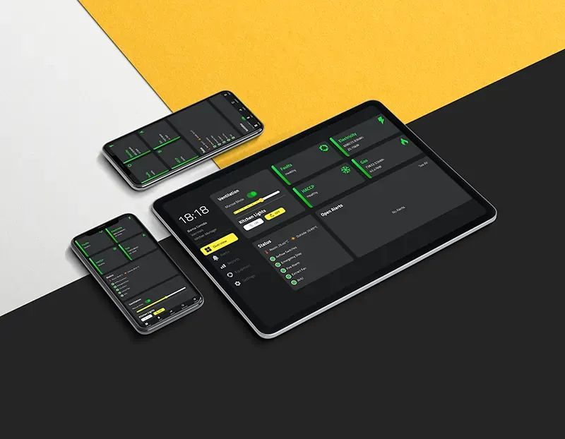 The Kioti operations app on a tablet and two phones, showing equipment status and open alerts