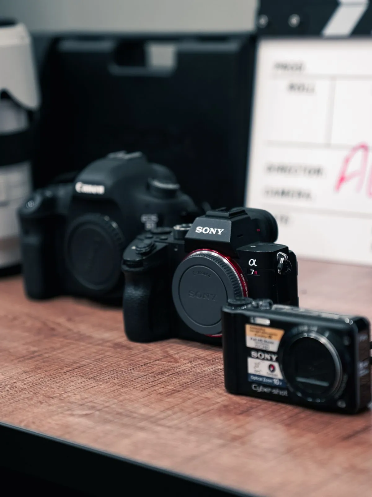 A row of cameras lined up on a table
