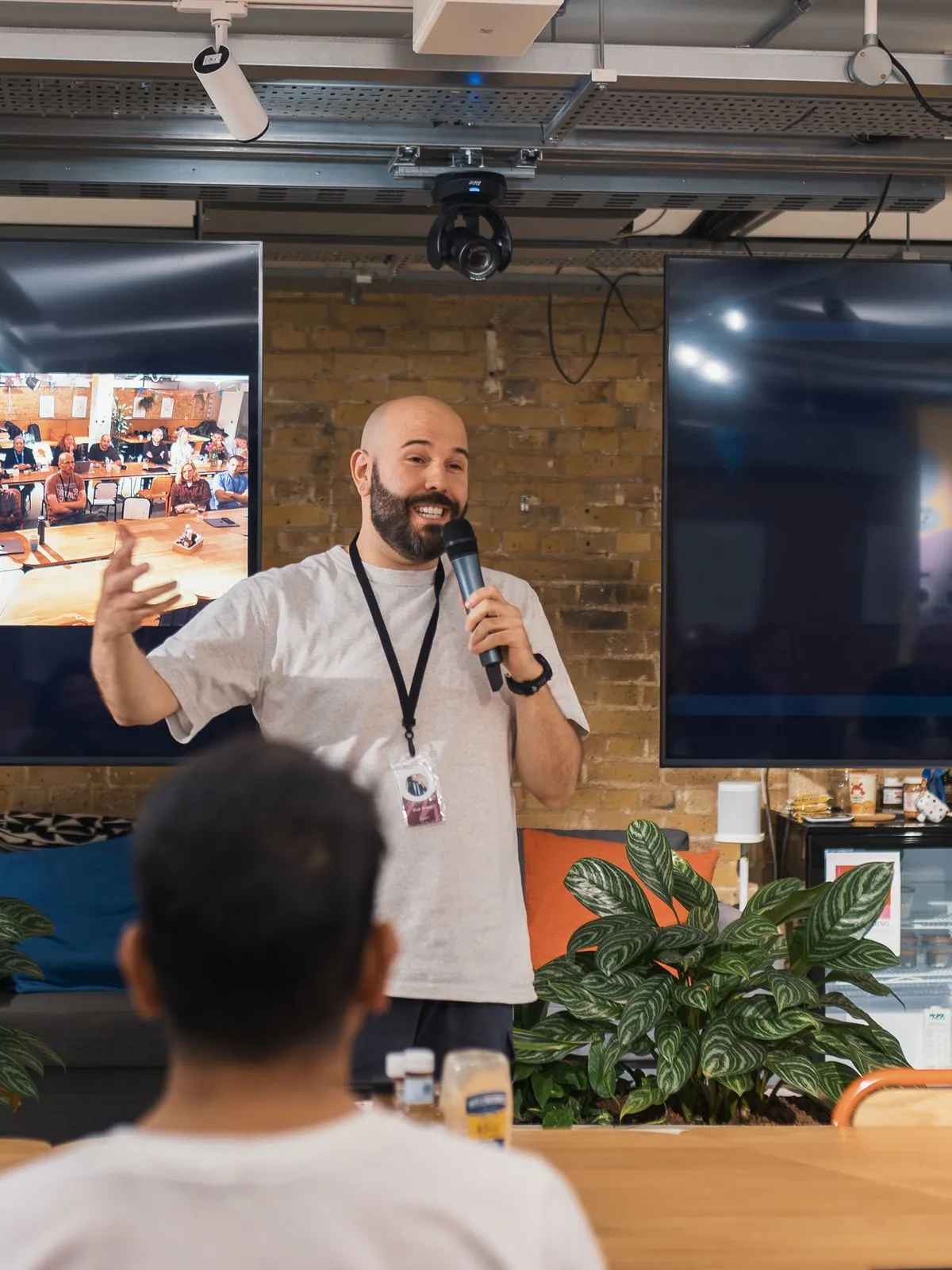 A speaker addressing a room of adults at a training workshop